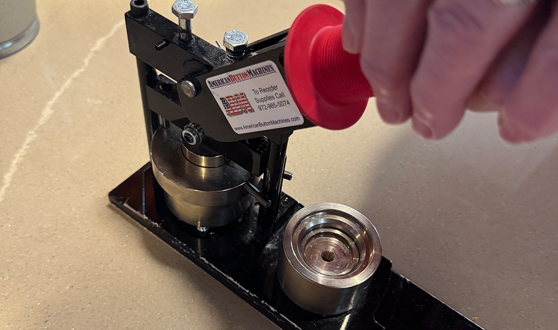 The second part of Step 5 in Button Making 101 is to pull the handle all the way down