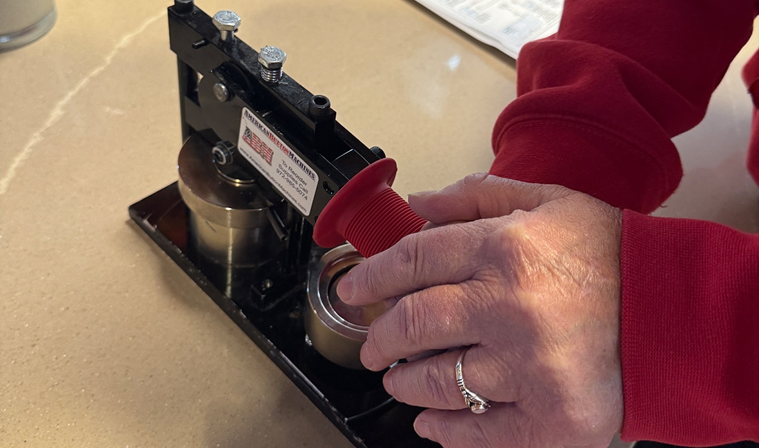 The second part of Step 7 in Button Making 101 is to pull the handle all the way down