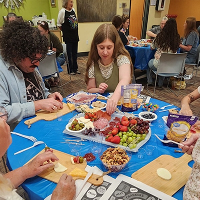 Adults learning how to make charcuterie boards at the Hudson Public Library