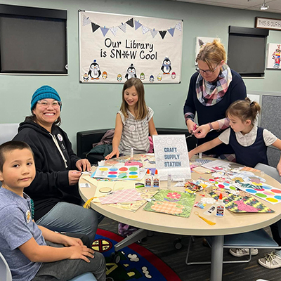 Family working on seasonal crafts offered through the Family Programs at the Hudson Public Library