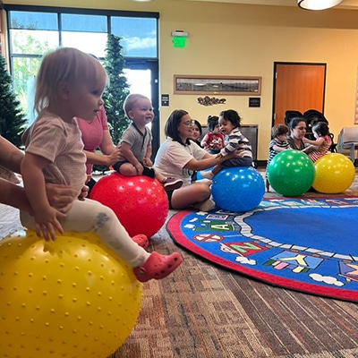 Toddlers on yoga balls at the Hudson Public Library