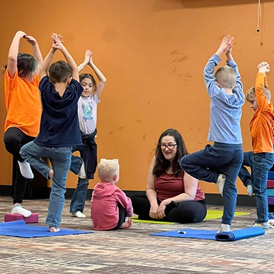 Young children doing yoga at the Hudson Public Library